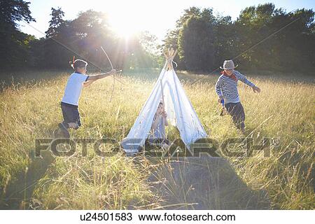 Small group of young boys playing around teepee View Large Photo Image Stock Image - Small group of young boys playing around teepee. Fotosearch