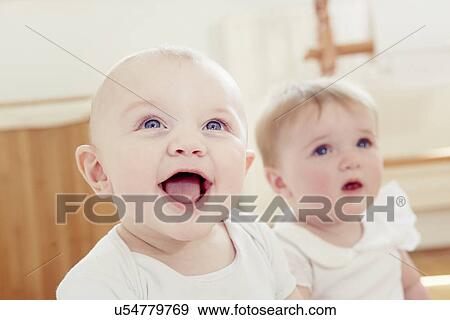 Stock Photo - Smiling baby boy with baby girl. Fotosearch