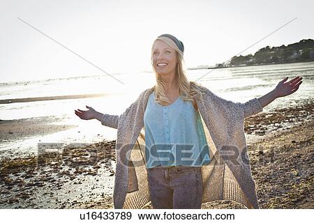 Stock Photo - Smiling young woman on Bournemouth beach, Dorset, UK. Fotosearch