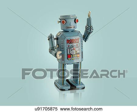 Stock Photography - Studio shot of blue robot with arm raised. Fotosearch