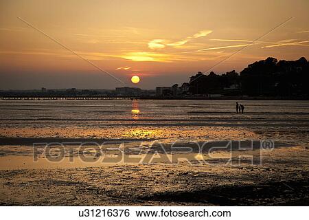 Stock Photograph - Sunset at beach, Bournemouth, Dorset, UK. Fotosearch