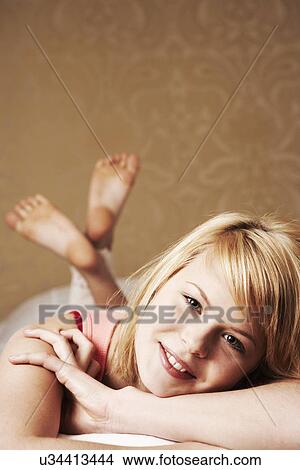 Picture - Teenage girl lying on front, portrait. Fotosearch