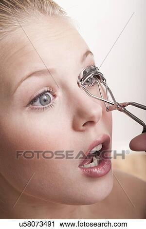 Teenage girl using eyelash curlers View Large Photo Image Stock Image - Teenage girl using eyelash curlers. Fotosearch