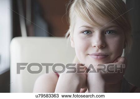 Teenage girl with hand on chin, portrait View Large Photo Image Stock Image - Teenage girl with hand on chin, portrait. Fotosearch