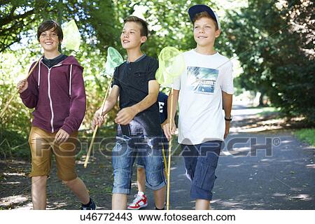 Stock Image - Three boys with fishing nets. Fotosearch