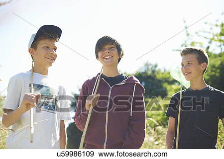 Stock Photo - Three boys with fishing nets. Fotosearch