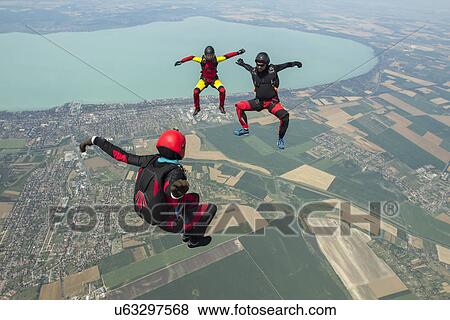 Stock Photo - Three skydivers freeflying in formation, Siofok, Somogy, Hungary. Fotosearch
