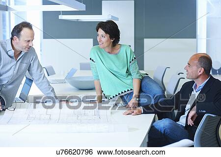 Three workers having business meeting View Large Photo Image Stock Photograph - Three workers having business meeting. Fotosearch