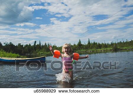 Three year old girl splashing in Indian river, Ontario, Canada View Large Photo Image Stock Photo - Three year old girl splashing in Indian river, Ontario, Canada. Fotosearch