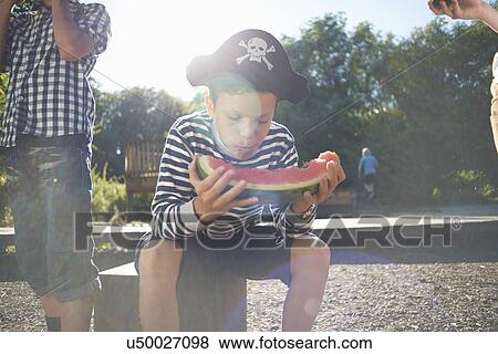 Three young boys having lunch in park View Large Photo Image Stock Photo - Three young boys having lunch in park. Fotosearch