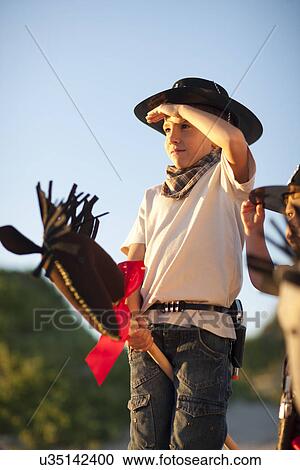 Two boys dressed as cowboys on hobby horses View Large Photo Image Stock Image - Two boys dressed as cowboys on hobby horses. Fotosearch