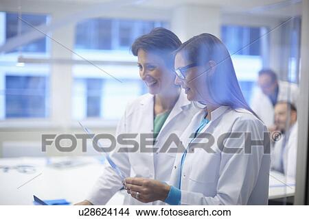 Picture - Two doctors looking at x-ray. Fotosearch