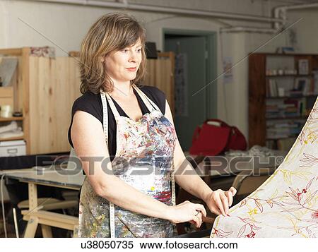 Woman checking fabric in hand-printed textile workshop View Large Photo Image Stock Photography - Woman checking fabric in hand-printed textile workshop. Fotosearch