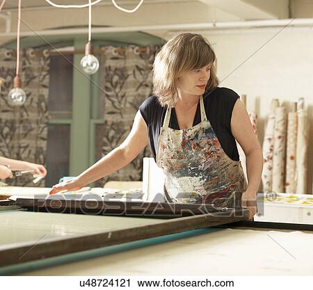 Woman hand-printing textile in workshop View Large Photo Image Stock Image - Woman hand-printing textile in workshop. Fotosearch