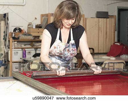 Woman hand-printing textile in workshop View Large Photo Image Stock Photo - Woman hand-printing textile in workshop. Fotosearch