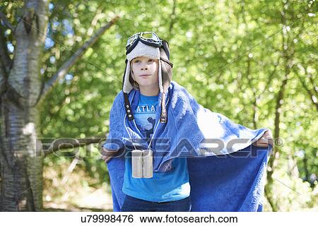 Stock Photograph - Young boy in fancy dress, playing in park. Fotosearch