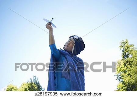 Young boy in fancy dress, playing with toy aeroplane View Large Photo Image Stock Photography - Young boy in fancy dress, playing with toy aeroplane. Fotosearch