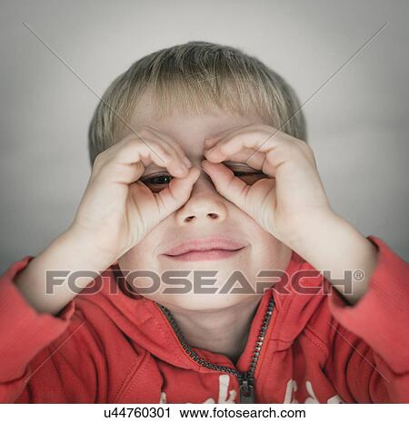 Young boy pretending to wear glasses, portrait View Large Photo Image Stock Image - Young boy pretending to wear glasses, portrait. Fotosearch