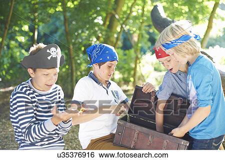 Young boys dressed as pirates with treasure chest View Large Photo Image Stock Photograph - Young boys dressed as pirates with treasure chest. Fotosearch