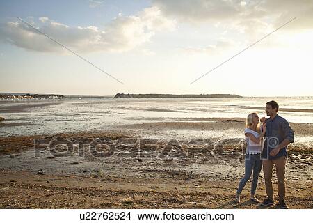 Young couple enjoying beach View Large Photo Image Picture - Young couple enjoying beach. Fotosearch