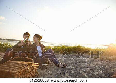 Young couple picnicing on Bournemouth beach, Dorset, UK View Large Photo Image Stock Image - Young couple picnicing on Bournemouth beach, Dorset, UK. Fotosearch