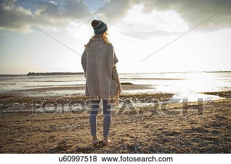 Stock Photo - Young woman gazing on Bournemouth beach, Dorset, UK. Fotosearch