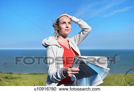 Young woman holding map by sea View Large Photo Image Stock Image - Young woman holding map by sea. Fotosearch