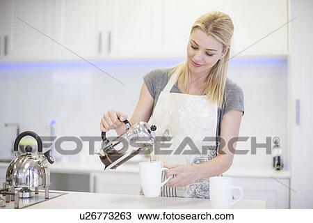 Young woman pouring a coffee from french press in kitchen View Large Photo Image Stock Image - Young woman pouring a coffee from french press in kitchen. Fotosearch