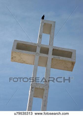 Bird sitting on a cross View Large Photo Image Stock Image - Bird sitting on a cross. Fotosearch