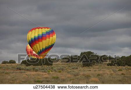 Stock Photo - Hot air balloons landing . Fotosearch