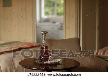 Stock Image - Liquor bottle on a table . Fotosearch