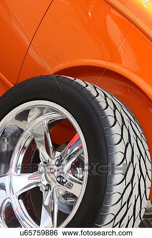 Orange car with new tire View Large Photo Image Stock Photograph - Orange car with new tire . Fotosearch
