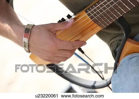 Stock Image - Playing the guitar . Fotosearch