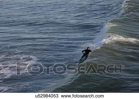 Stock Image - Riding the wave . Fotosearch