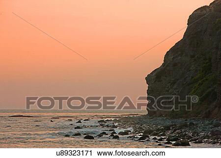 Sunset over the rocky shore View Large Photo Image Stock Image - Sunset over the rocky shore. Fotosearch