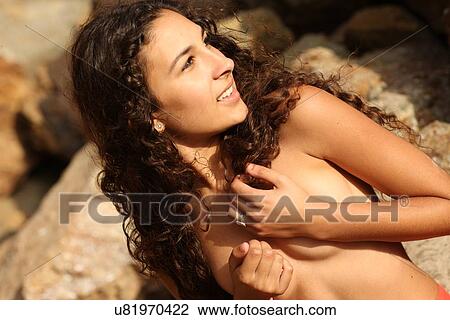 Topless woman on rocks View Large Photo Image Stock Image - Topless woman on rocks. Fotosearch