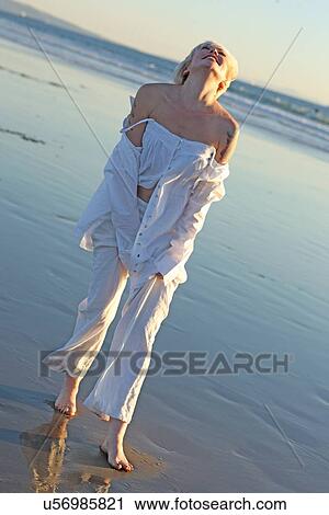 Woman looking up on a beach View Large Photo Image Stock Image - Woman looking up on a beach . Fotosearch