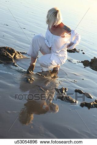 Woman posing in water View Large Photo Image Stock Photograph - Woman posing in water. Fotosearch