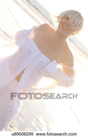 Stock Photography - Woman smiling on a beach . Fotosearch