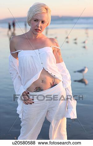 Stock Photo - Woman standing on the shore . Fotosearch