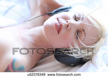 Woman wearing headphones View Large Photo Image Stock Photo - Woman wearing headphones. Fotosearch