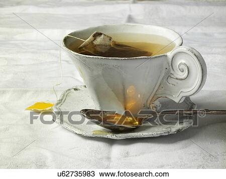 Stock Image - Antique teacup on table. Fotosearch