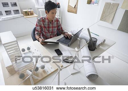 Architect working in office View Large Photo Image Stock Image - Architect working in office. Fotosearch