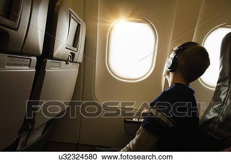 Stock Image - Boy (6-7) in plane. Fotosearch