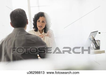 Business people talking at desk in office View Large Photo Image Stock Image - Business people talking at desk in office. Fotosearch