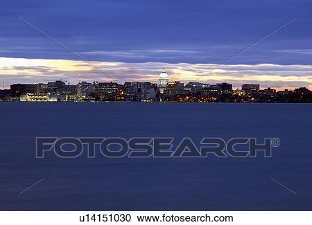 Stock Image - City skyline at sunset. Fotosearch