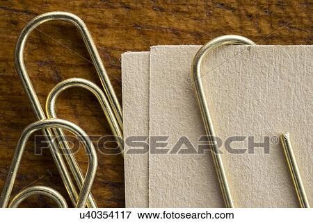 Stock Photo - Close up of paper clips and paper. Fotosearch