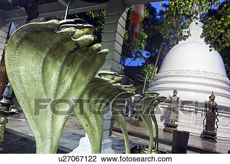 Stock Image - Cobra statues in front of stupa in Gangaramaya Temple area. Fotosearch