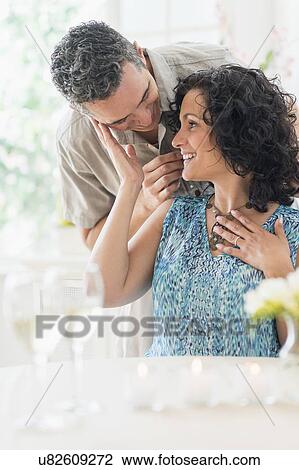 Stock Image - Couple celebrating anniversary in restaurant. Fotosearch