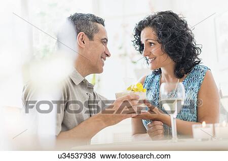 Stock Photo - Couple celebrating anniversary in restaurant. Fotosearch